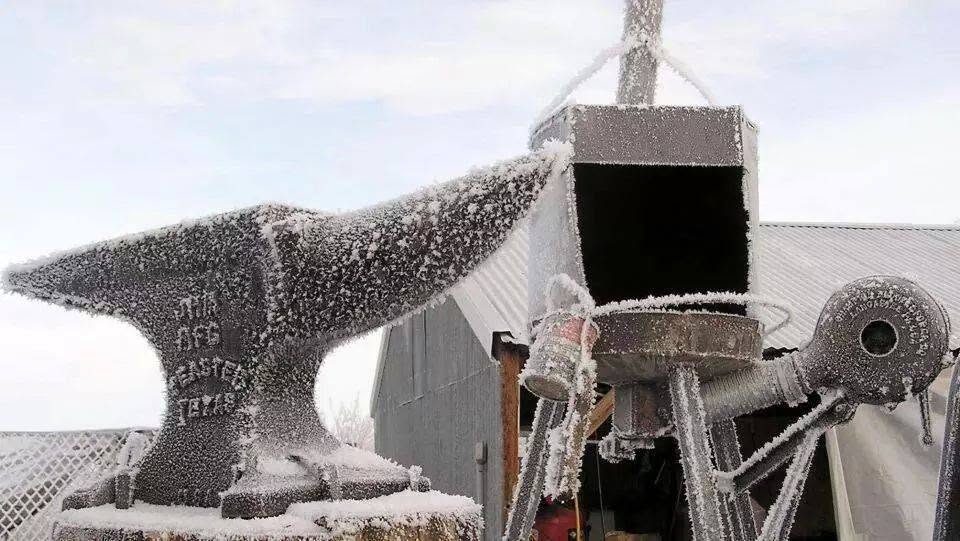 Frost-covered anvil and forge
